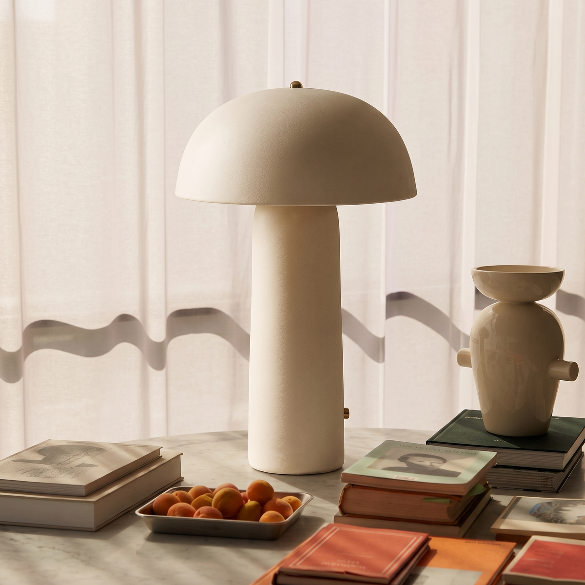 Adora Ivory table lamp on a side table in a living room